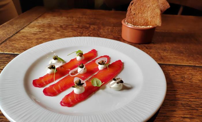 Salmon cured in beetroot, yogurt, crispy capers, pickled shallots, sourdough crostini